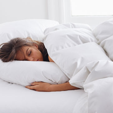 Woman asleep with LaCrosse™ Comforter